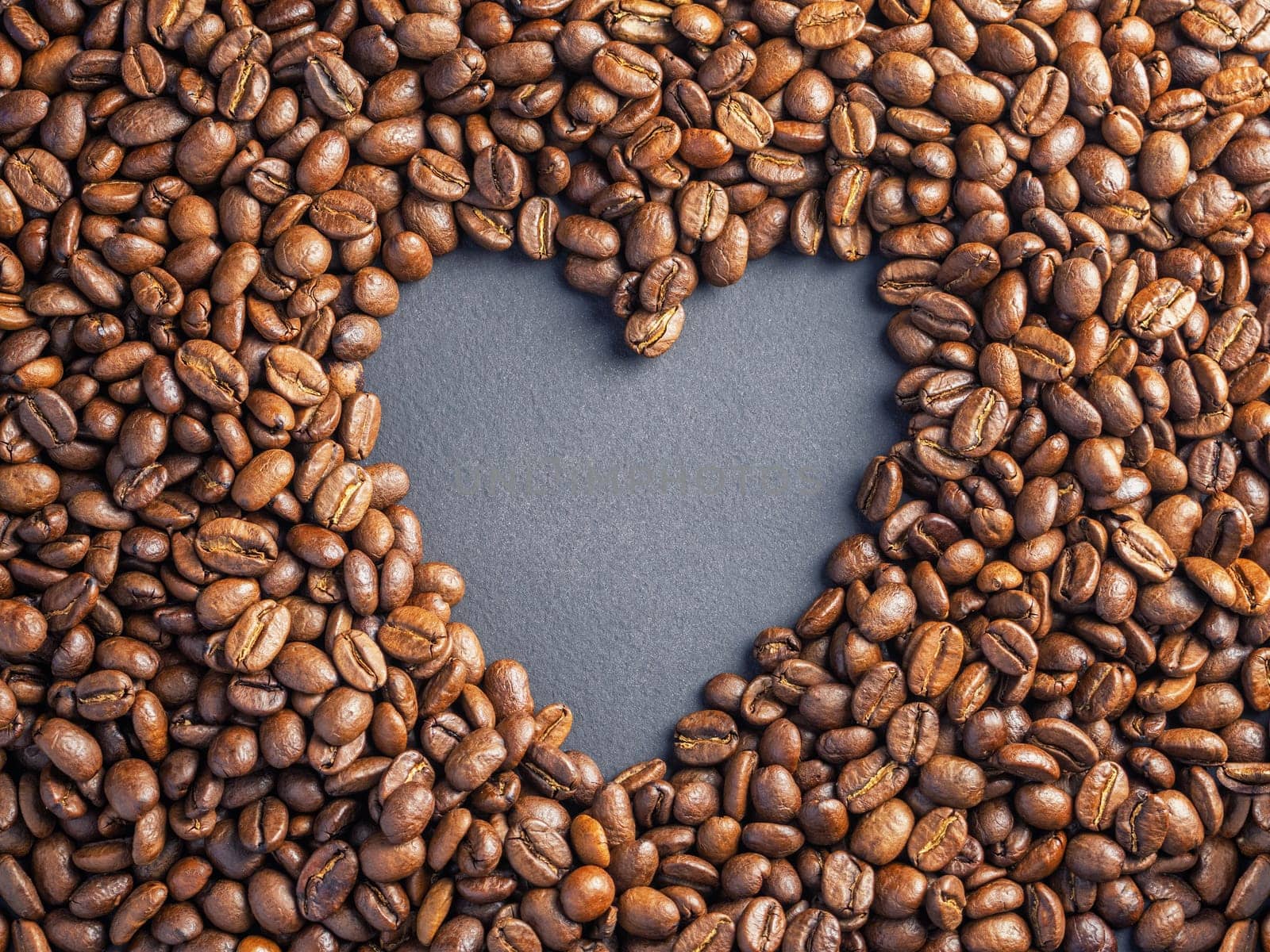 Heart coffee frame made of coffee beans on burlap texture.