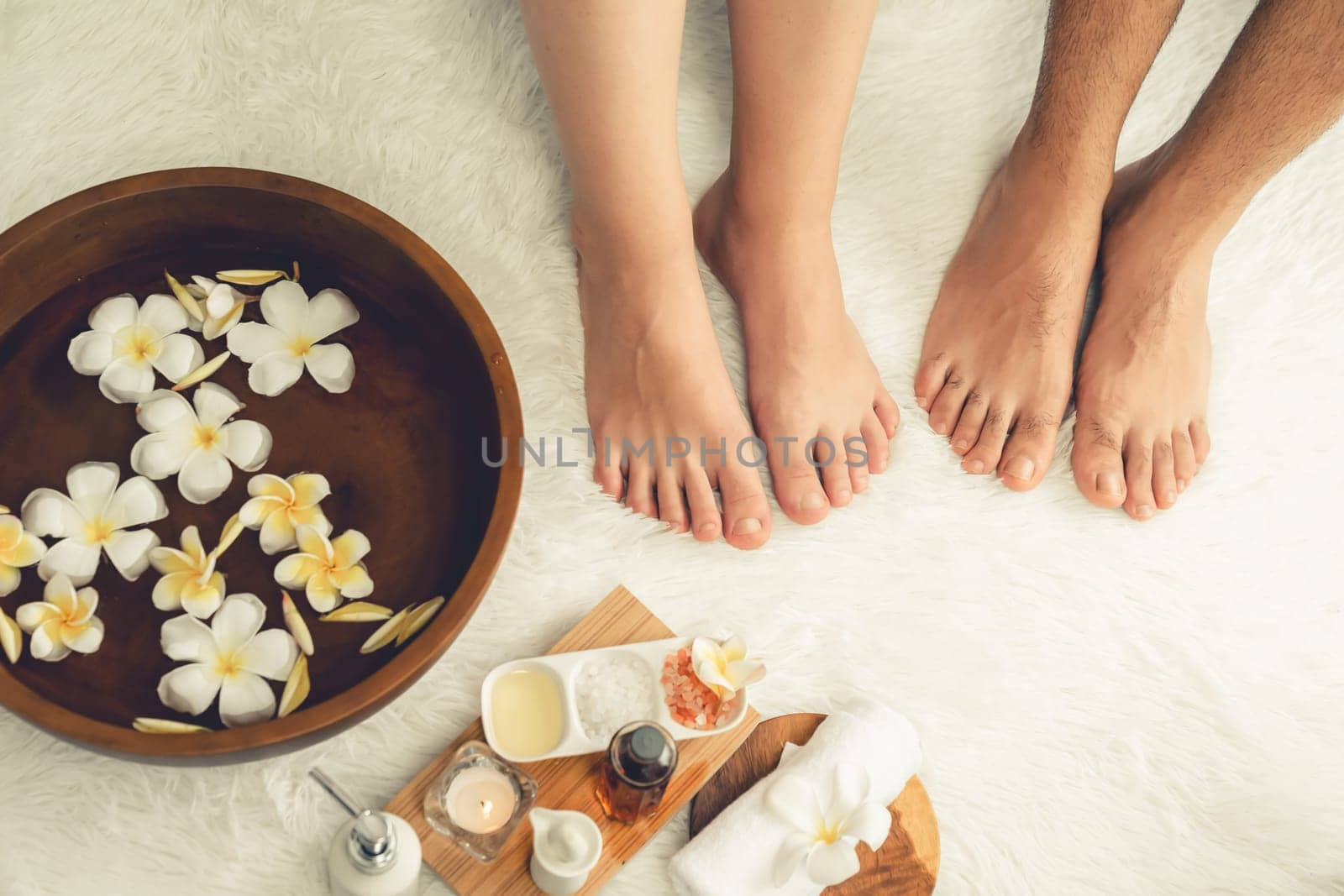 Couple indulges in blissful foot massage at luxurious spa salon. Quiescent by biancoblue