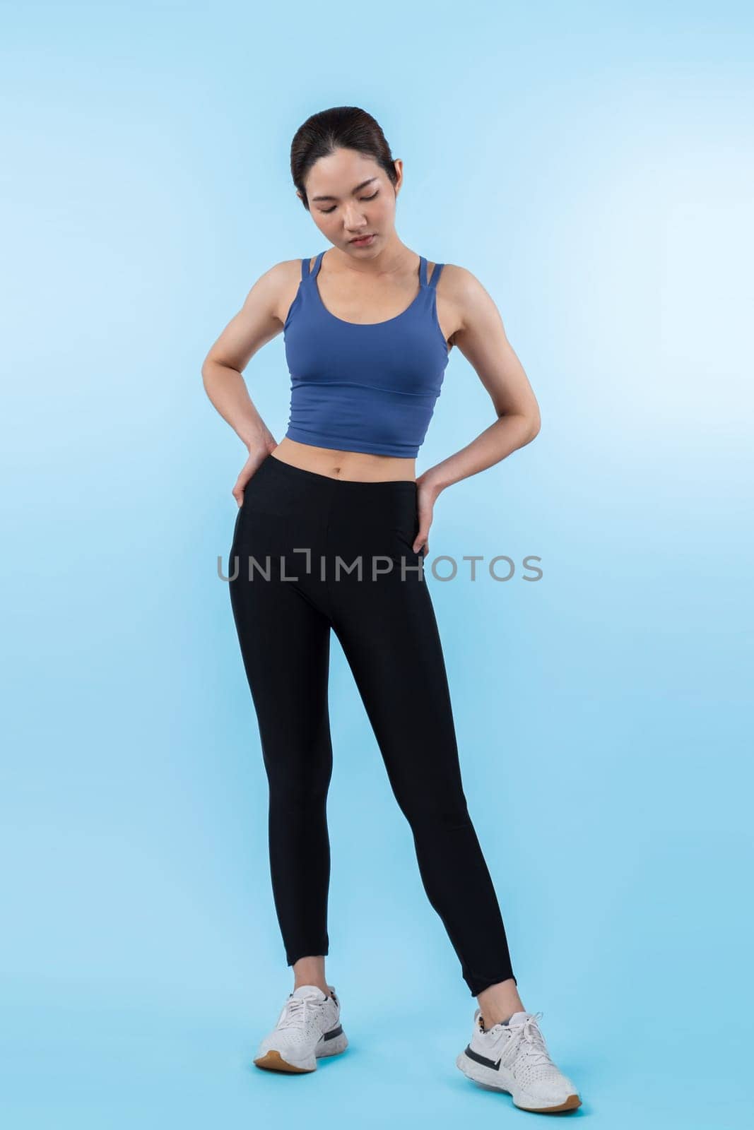 Full body asian woman in sportswear portrait, smiling and posing cheerful gesture. Workout training with attractive girl engage in her pursuit of healthy lifestyle. Isolated background Vigorous