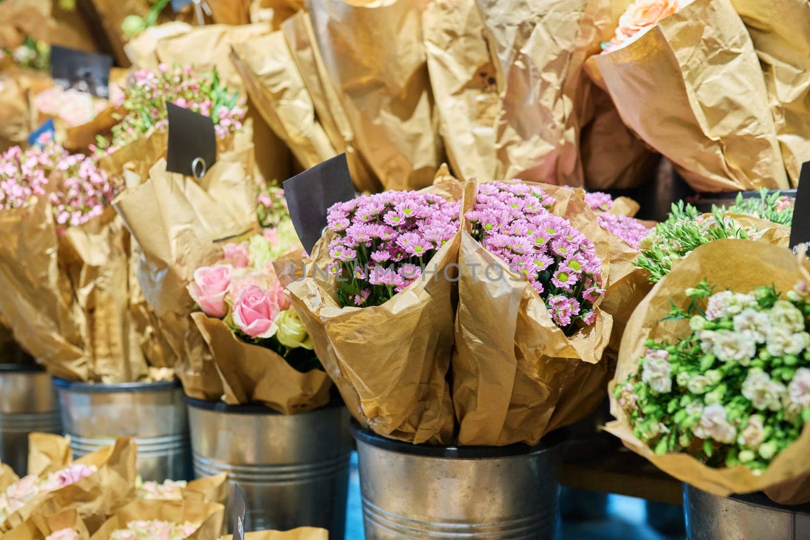 Flower shop, close-up of fresh flowers in buckets, pink chrysanthemums. Floristics, small business, flower decoration of apartments, houses, offices, gifts for holidays, summer autumn season