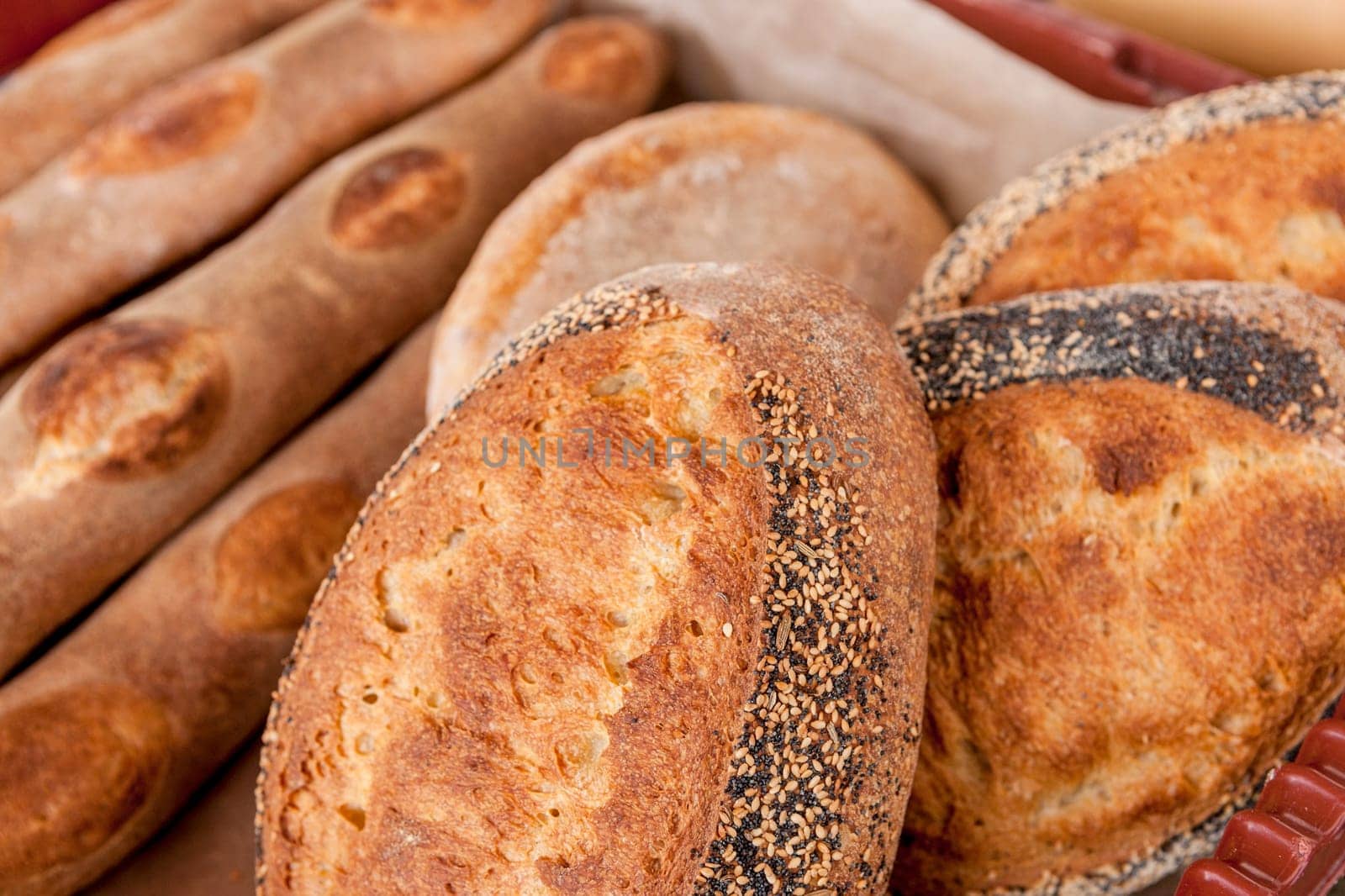 Various loaves of home made bread on display at a market.