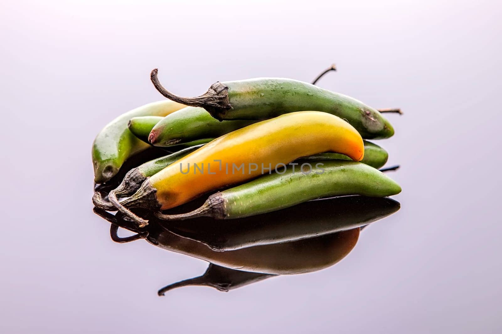 A close up studio image of a bunch of jalapeno peppers.