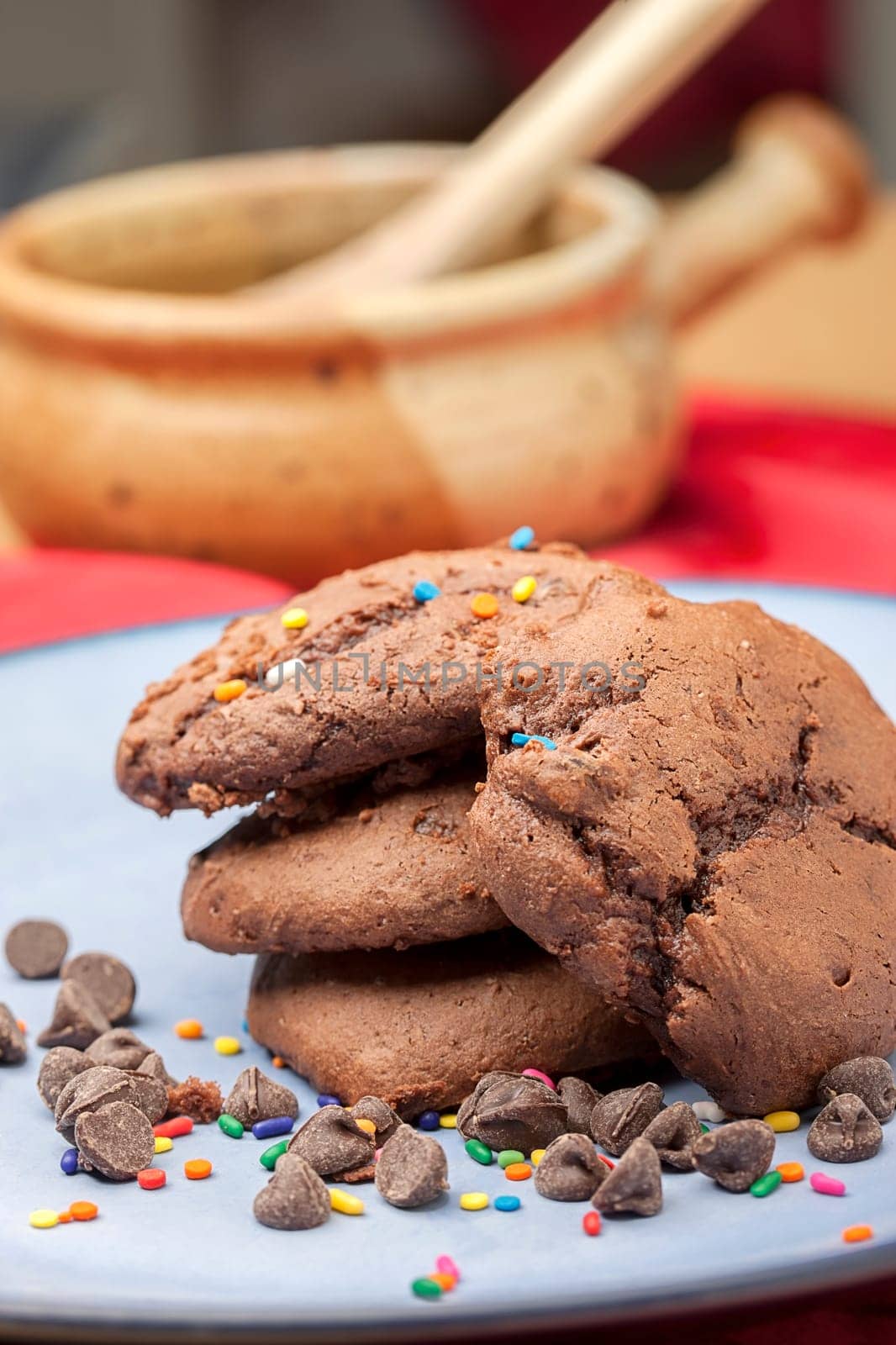 Close up photo of chocolate chip cookies with color sprinkles on them.