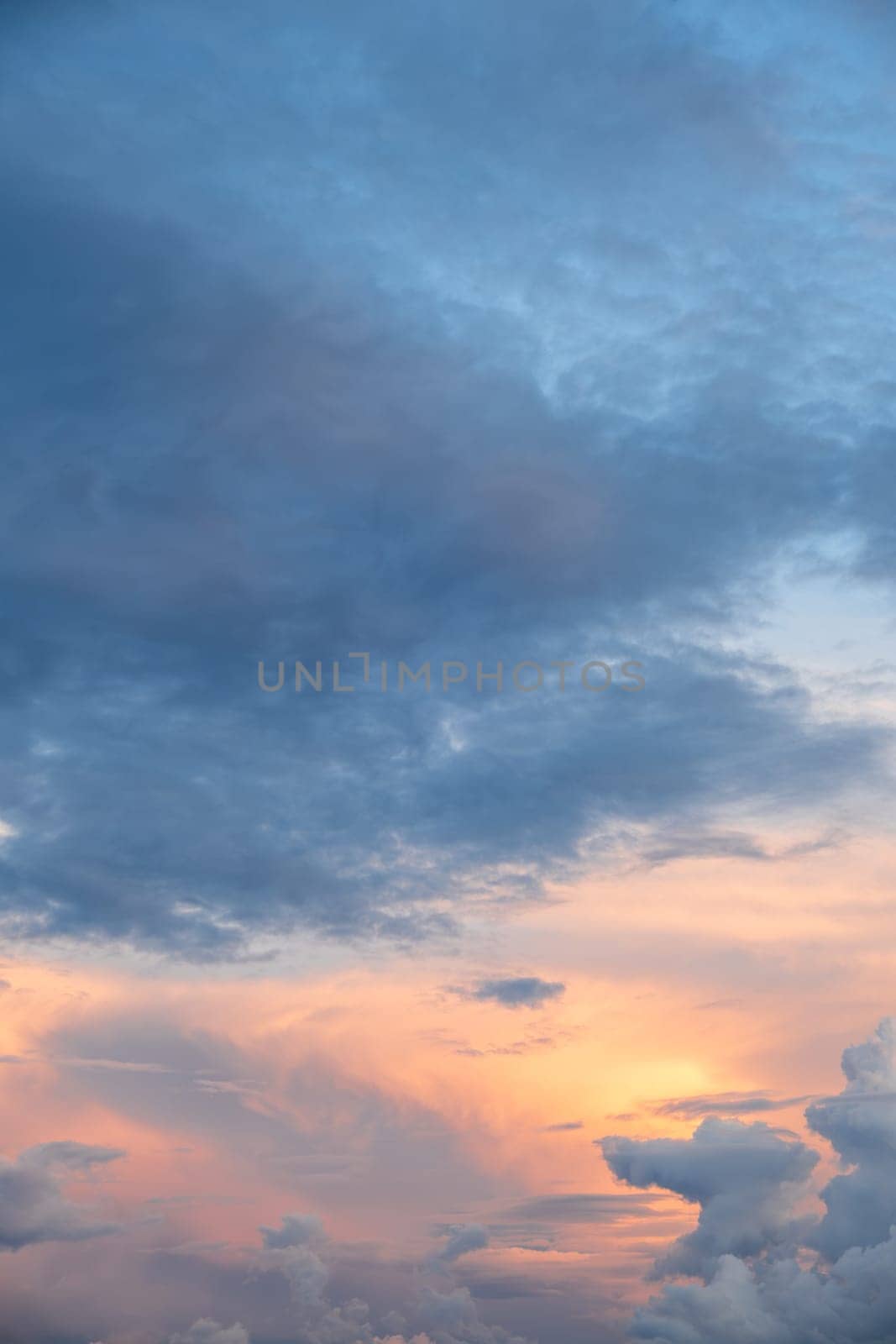 Sunset over the horizon: a mixture of orange and blue hues, the change of day to evening.