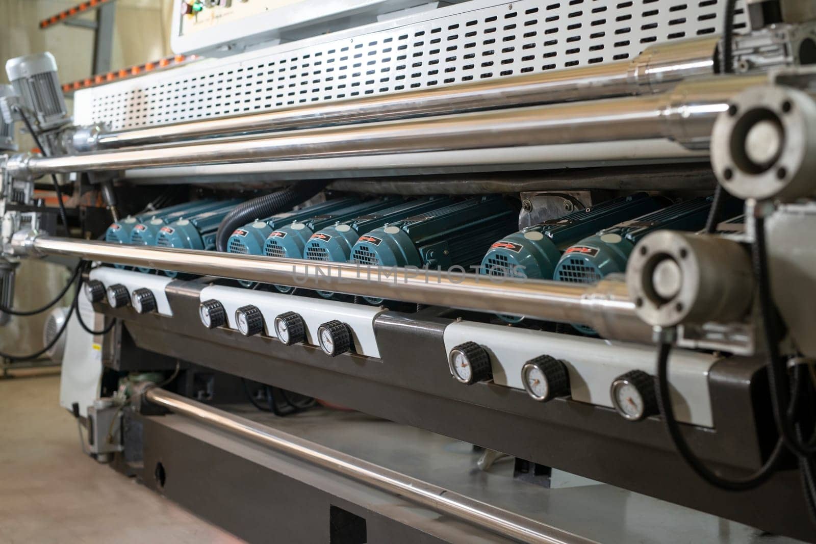 Metal construction with steel elements and spindle motors of automatic glass polishing machine in workshop