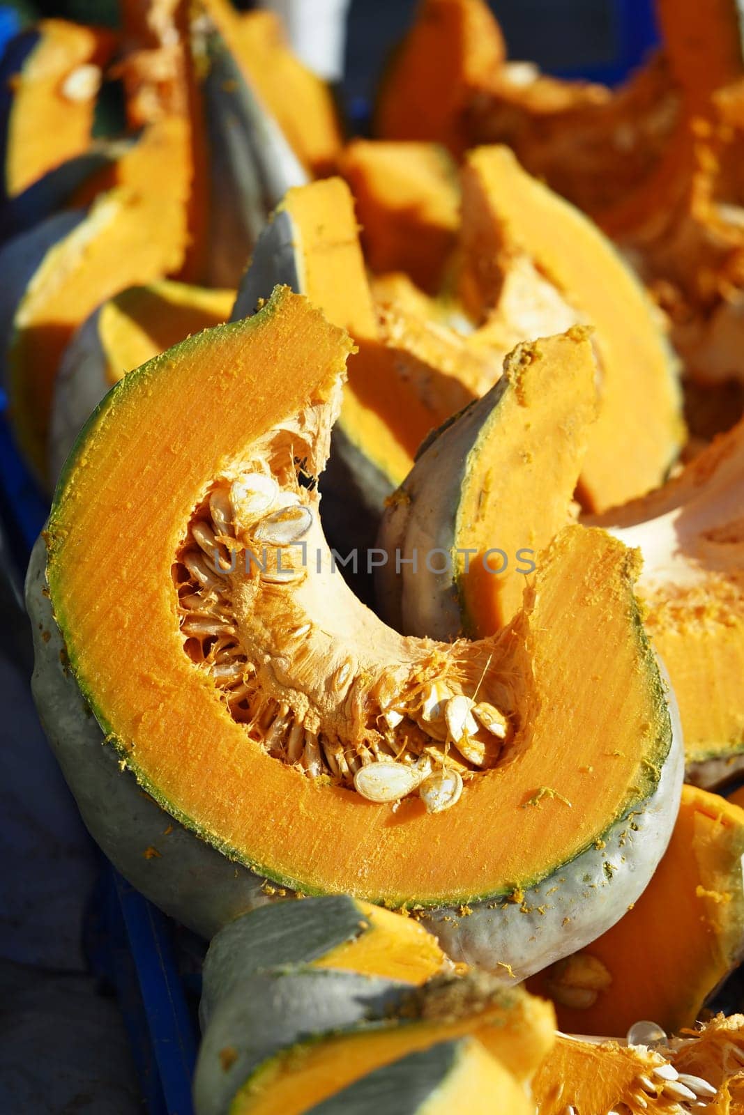 Bright orange pumpkin slices showcased for sale during fall harvest.