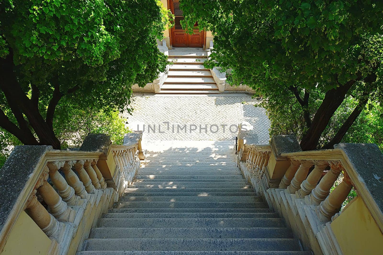 An old staircase with beautiful architectural railings leads down.