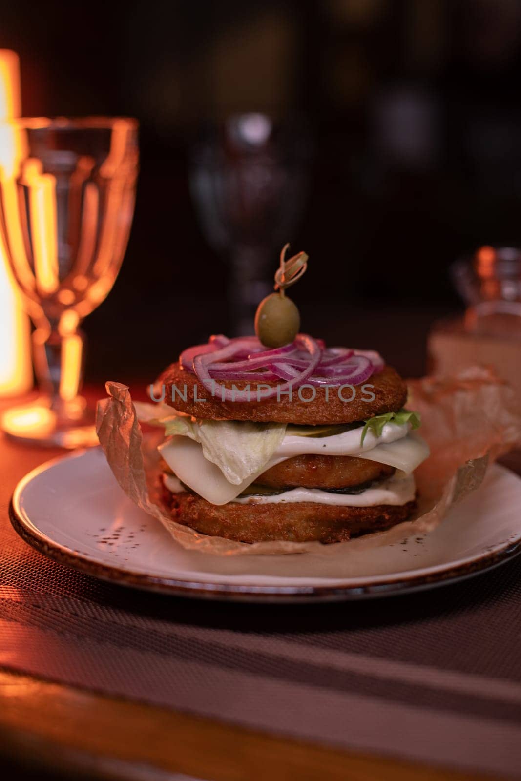 Juicy mouth-watering fatty burger made from grated potatoes and meat on the table in the restaurant.