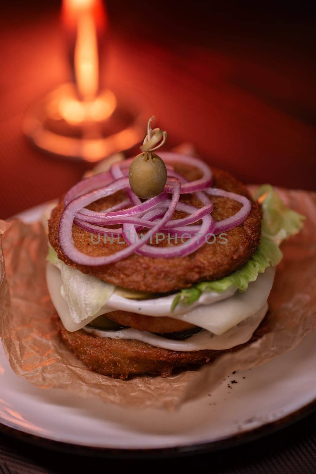 Juicy mouth-watering fatty burger made from grated potatoes and meat on the table in the restaurant.