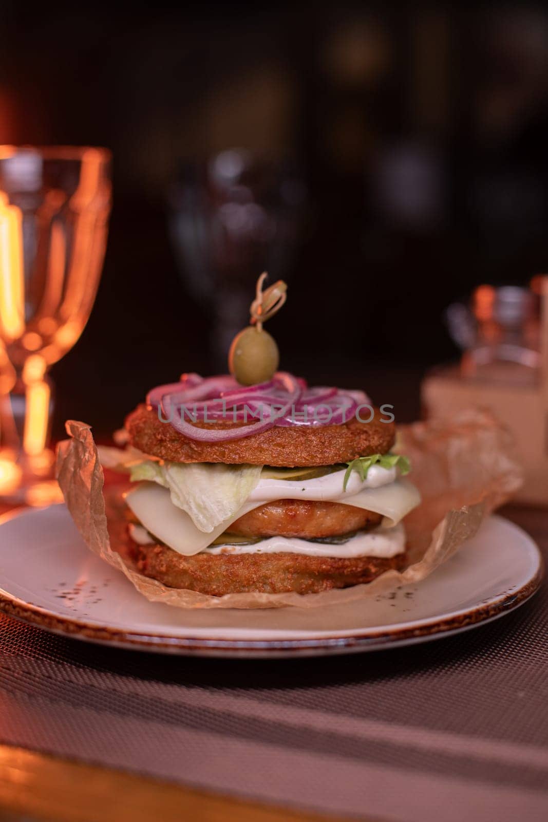 Juicy mouth-watering fatty burger made from grated potatoes and meat on the table in the restaurant.