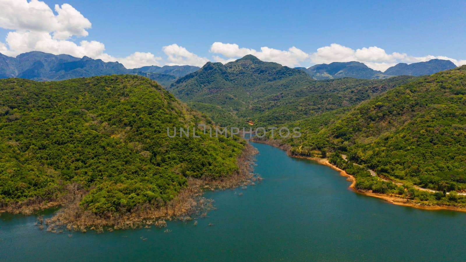 A beautiful lake among the mountains with a green forest. Kalu Ganga Reservoir, Sri Lanka.
