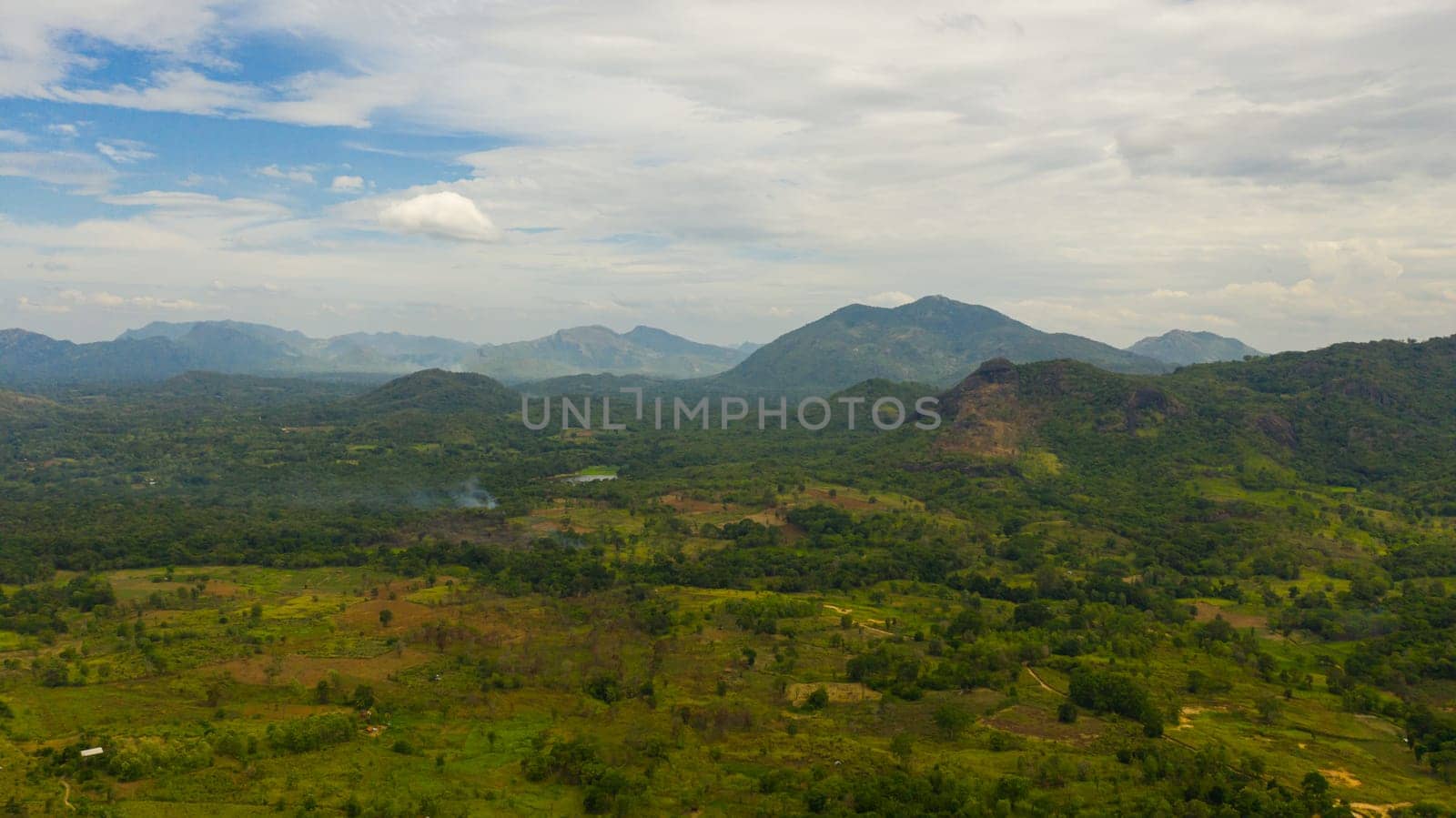 Farmlands and villages in a valley among tropical vegetation and jungle. Sri Lanka.