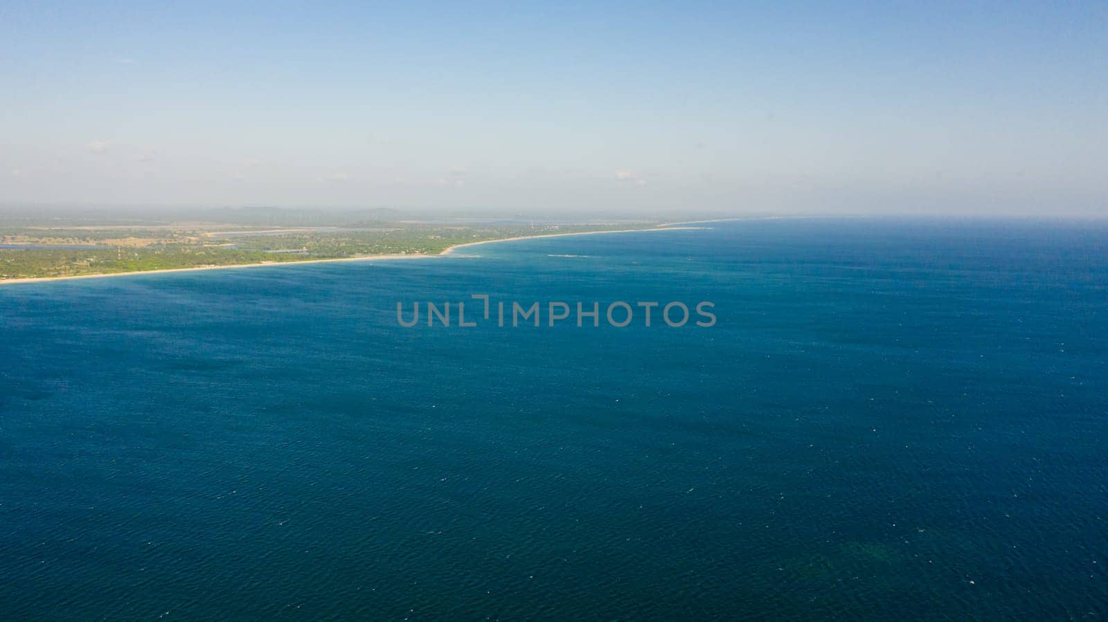 The sea coast of the island of Sri Lanka with a sandy beach. Nilaveli Beach, Trincomalee.