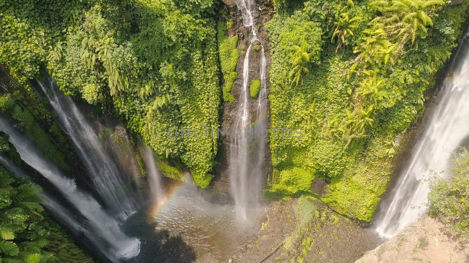 waterfall in green rainforest. Aerial view triple tropical waterfall Sekumpul in mountain jungle. Bali,Indonesia. Travel concept.