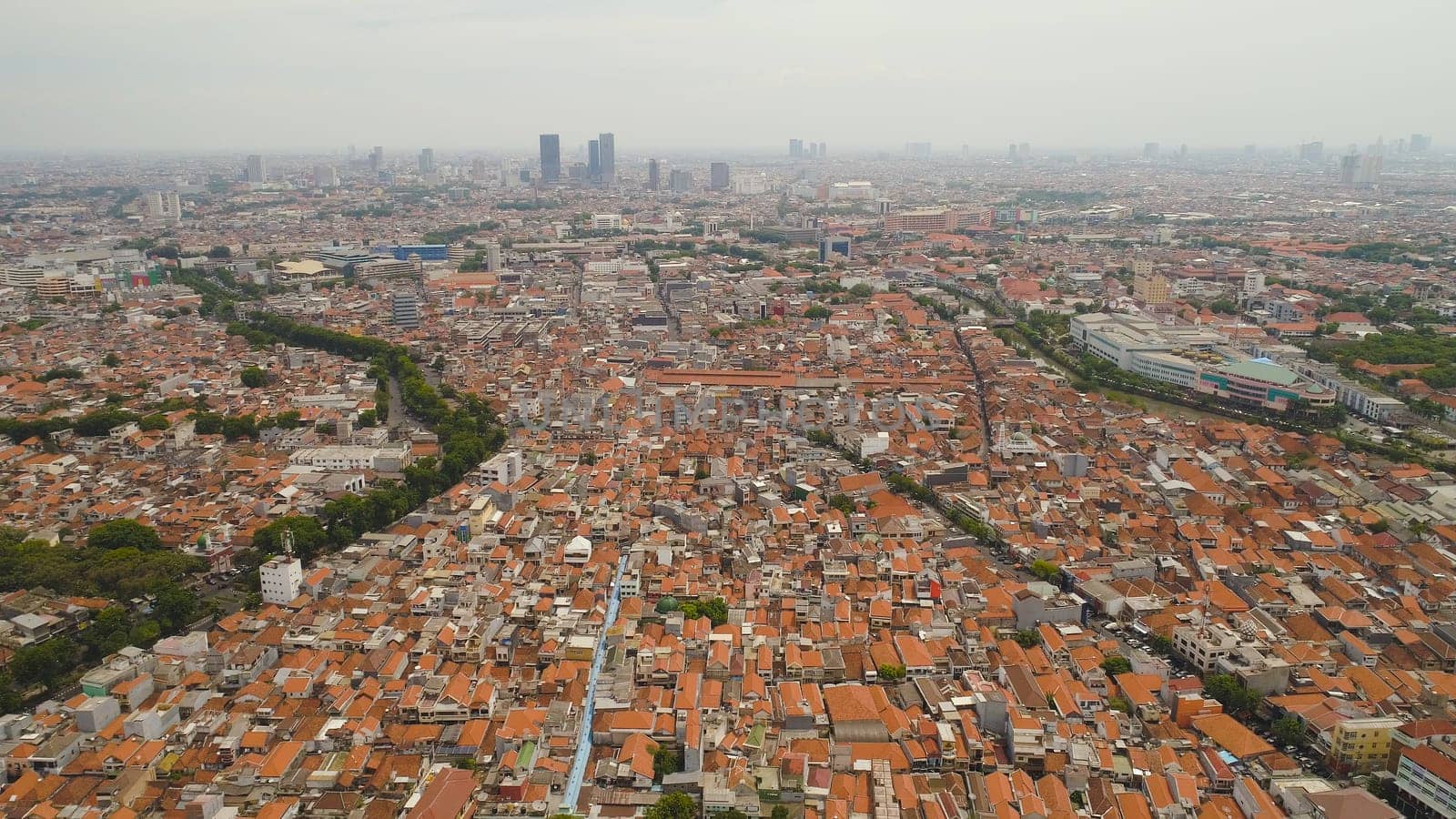 Aerial cityscape modern city Surabaya with skyscrapers, buildings and houses. urban environment in asia city skyline with skyscrapers and business centers java, indonesia