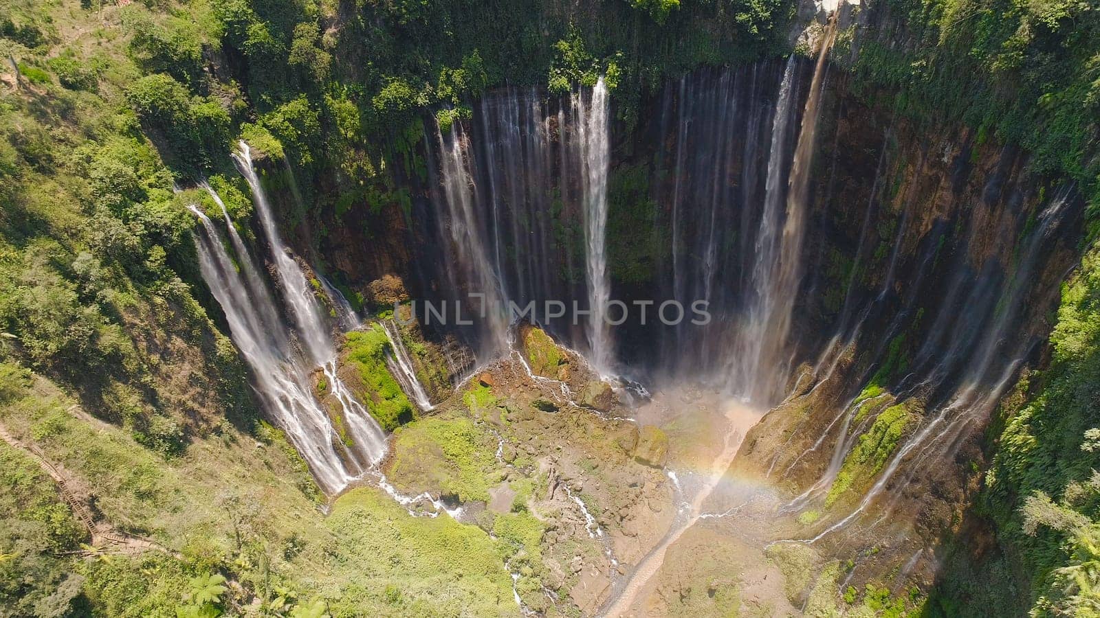 beautiful waterfall Coban Sewu in tropical forest, Java Indonesia. aerial view tumpak sewu waterfall in rainforest