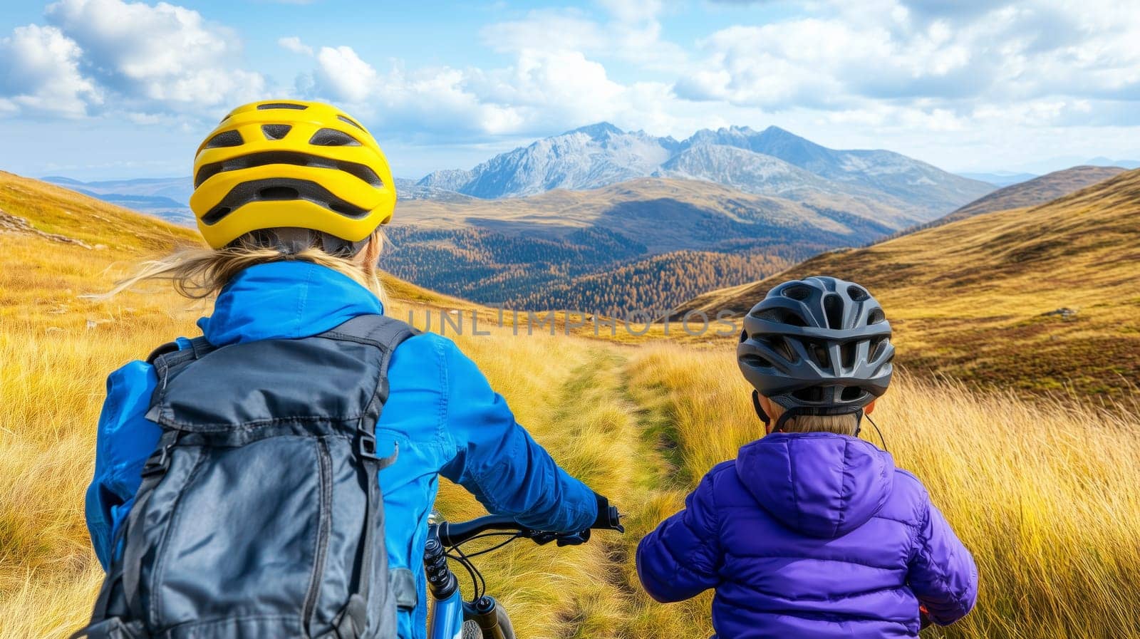 Two cyclists enjoying a sunny autumn day in the mountains riding their mountain bikes along a scenic trail