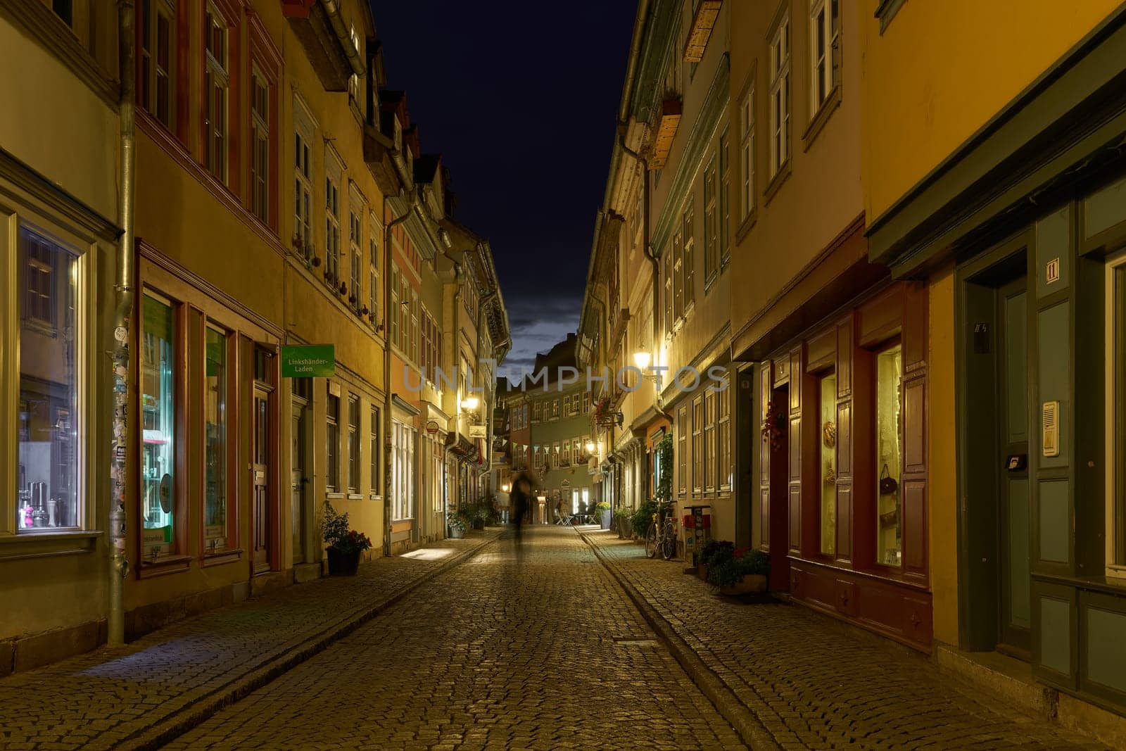 Erfurt, Germany – October 01, 2024: Erfurt, Germany – October 01, 2024: The Kramerbrucke in Erfurt in Germany with some stores in historic houses on both sides of the bridge at night