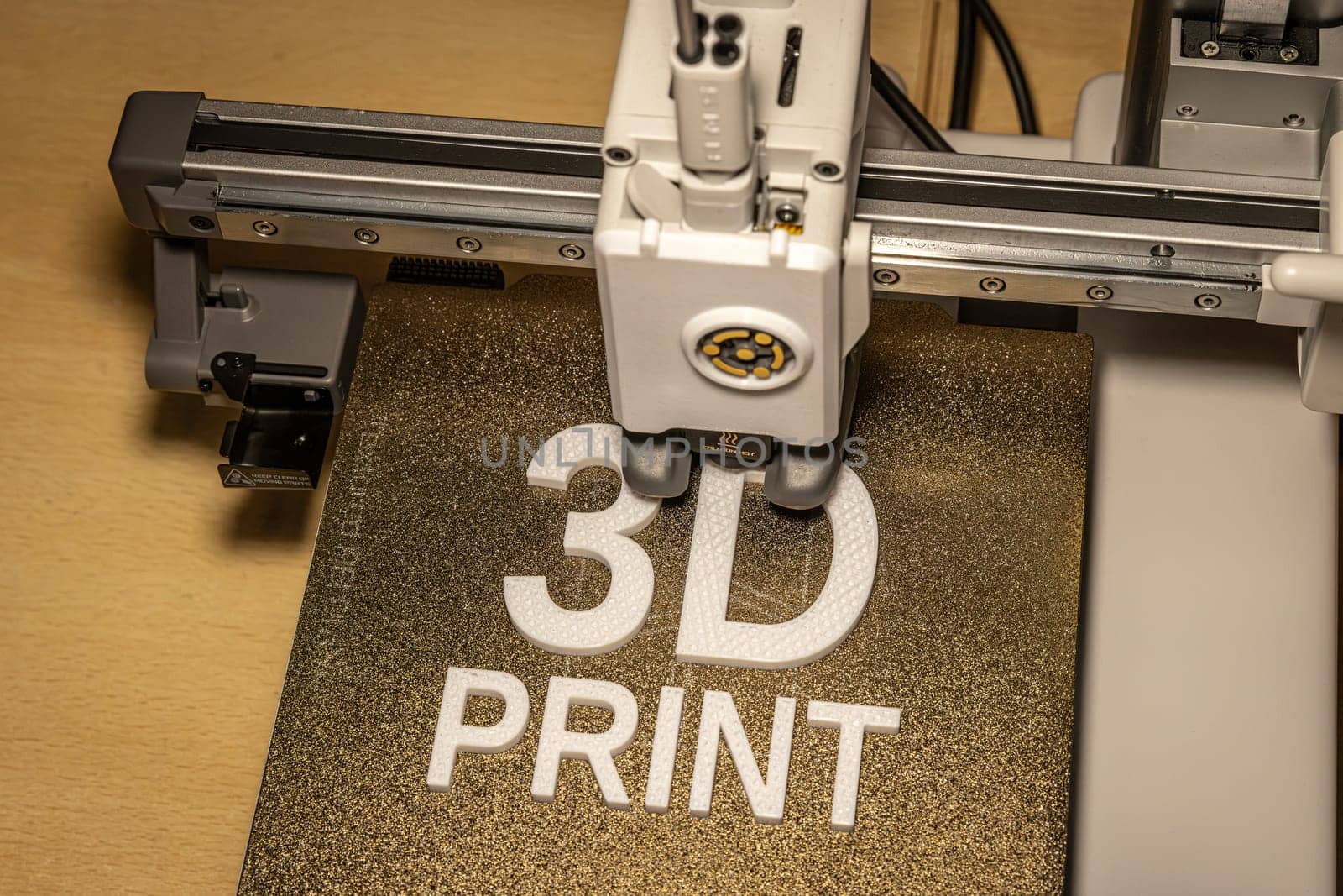 Modern 3d printer creating the words in white petg
