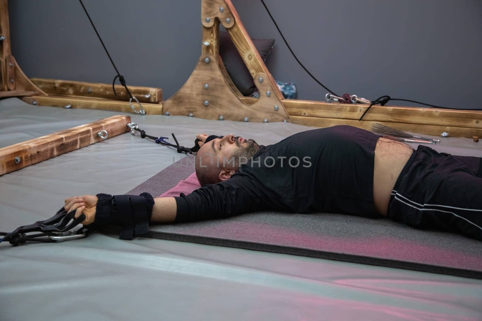 Caucasian man lying on a table during an alternative therapy session, suggesting relaxation and healing