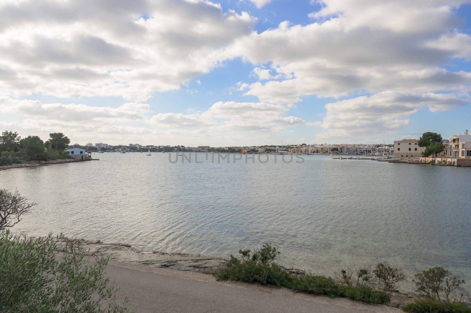 Portocolom, small bay, with the village and fishermen's houses in the background on a cloudy day Mallorca ,Balearic Islands, Spain