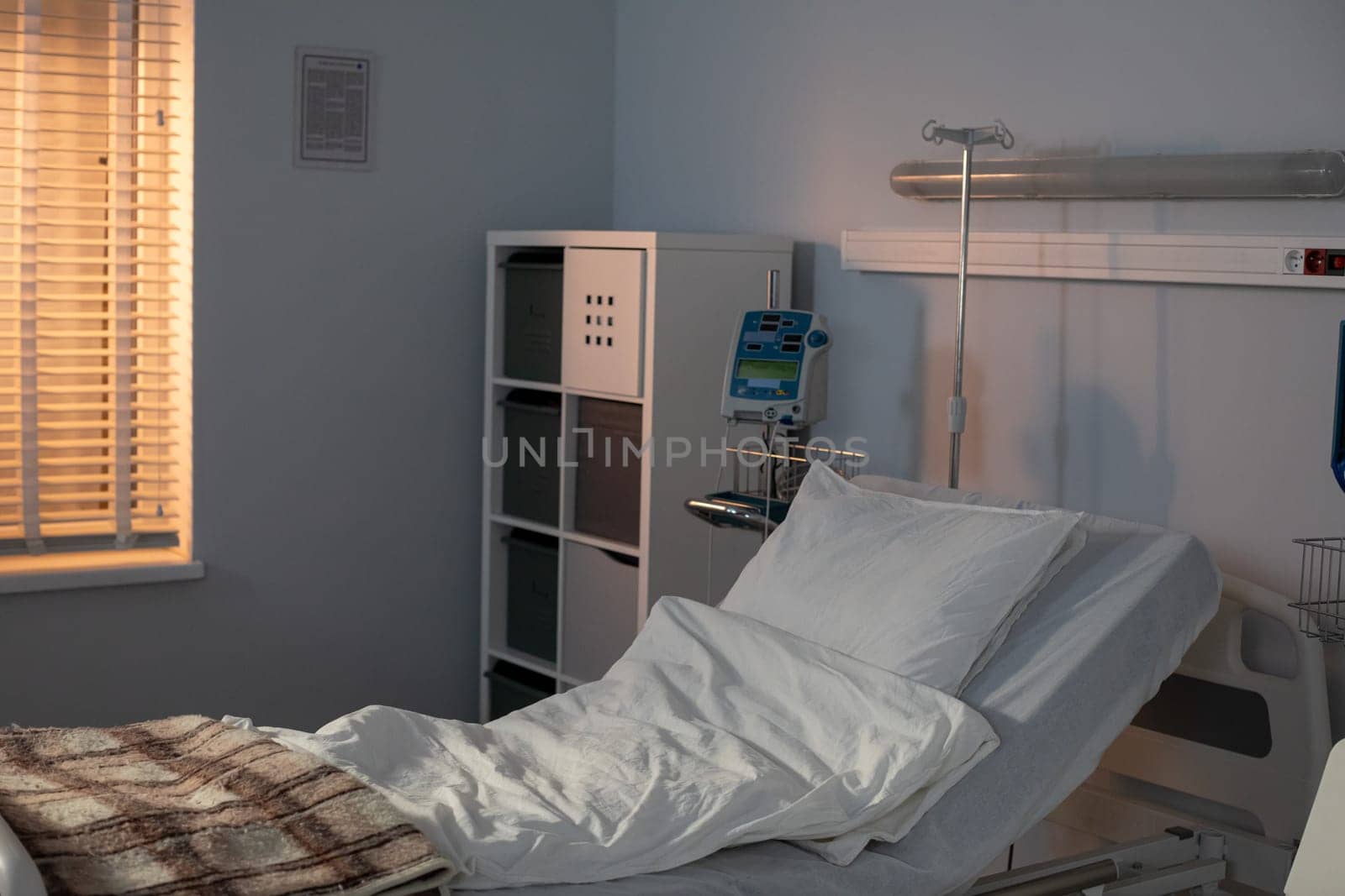 The peaceful and serene hospital room is designed with an adjustable bed, radiant sunlight, and a minimalist aesthetic