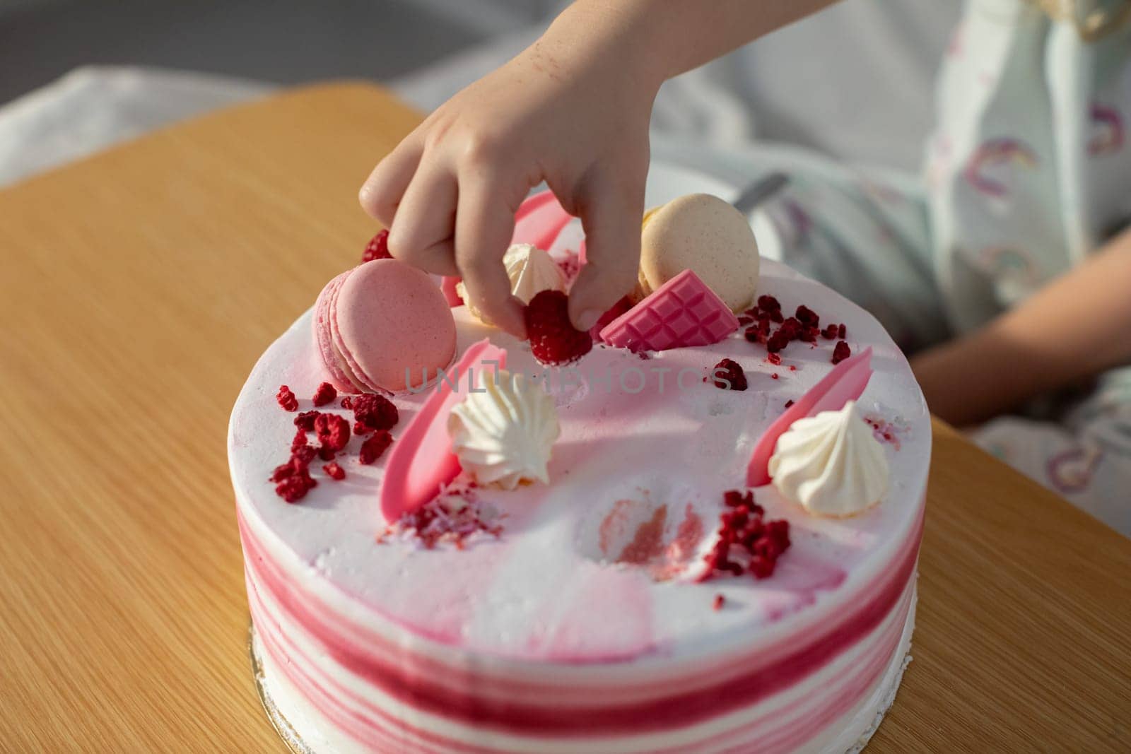 A closeup view of a delightful pink cake, beautifully topped with delicate decorations, ideal for any celebrations