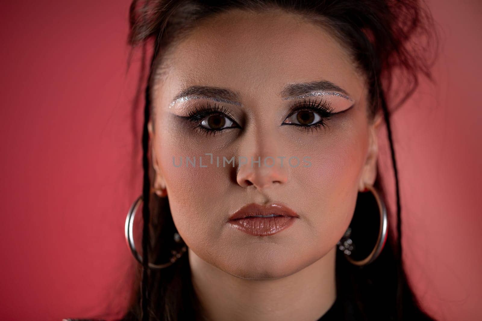 This striking and enchanting portrait features glamorous makeup along with a vibrant and colorful background