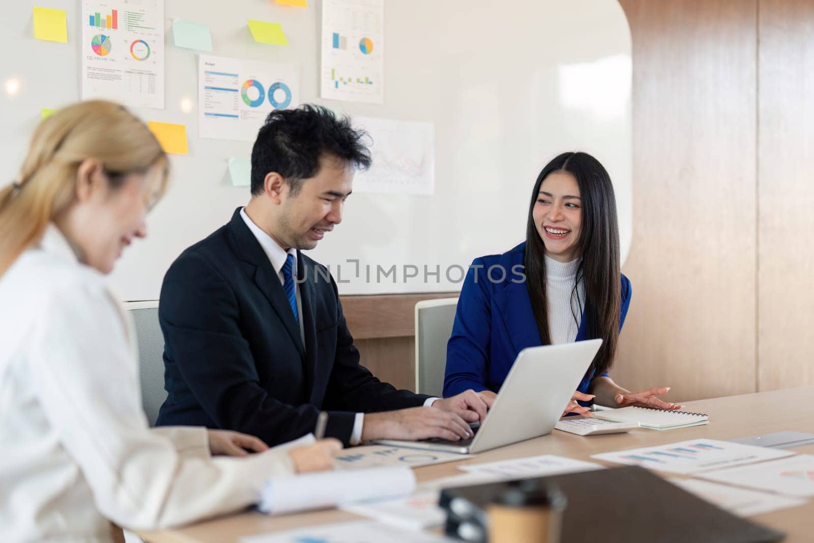 A multicultural business team working together on financial analysis, sharing ideas and insights in a dynamic and engaging office setting.