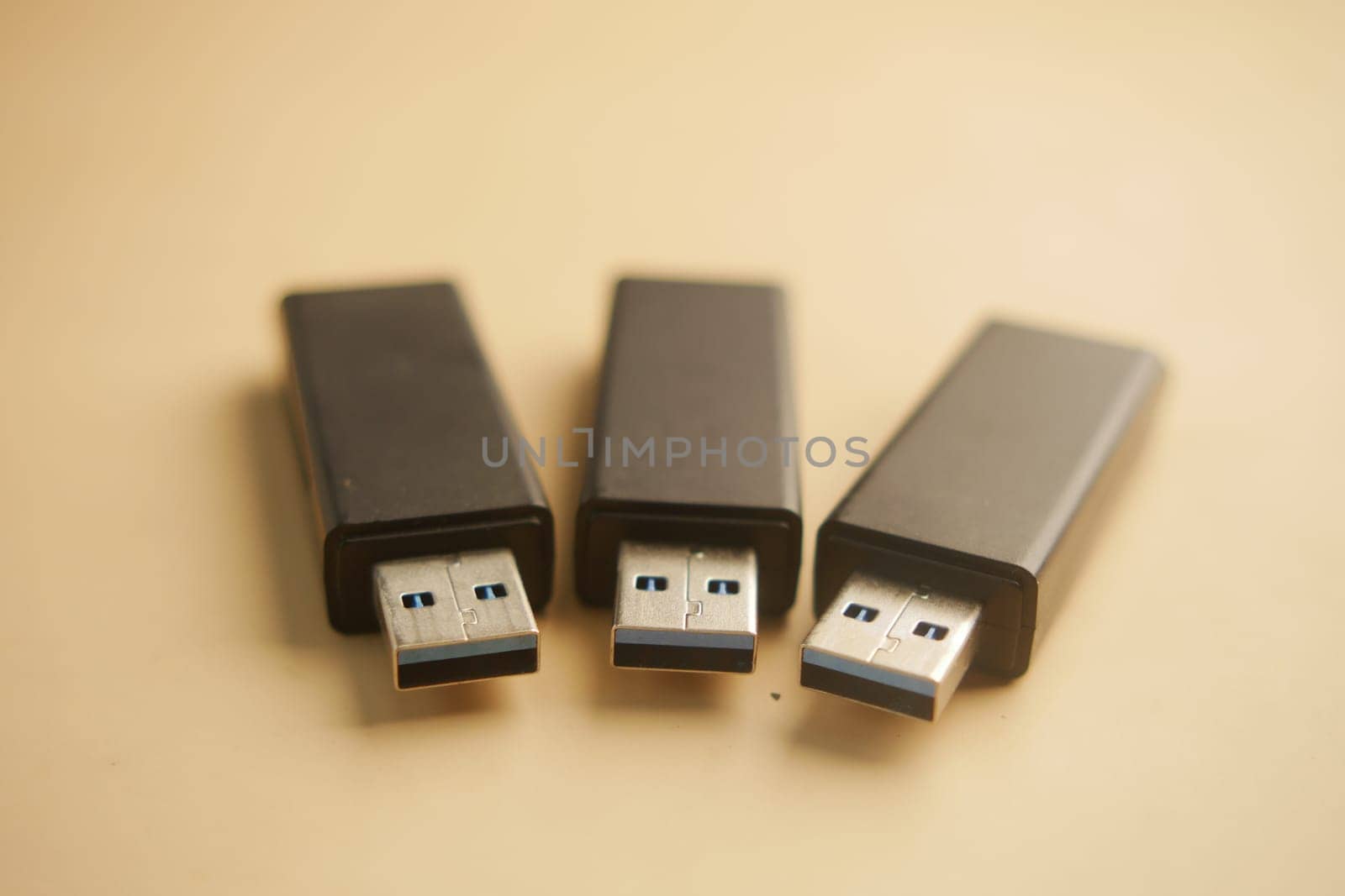 Three USB flash drives arranged in a row display their design.