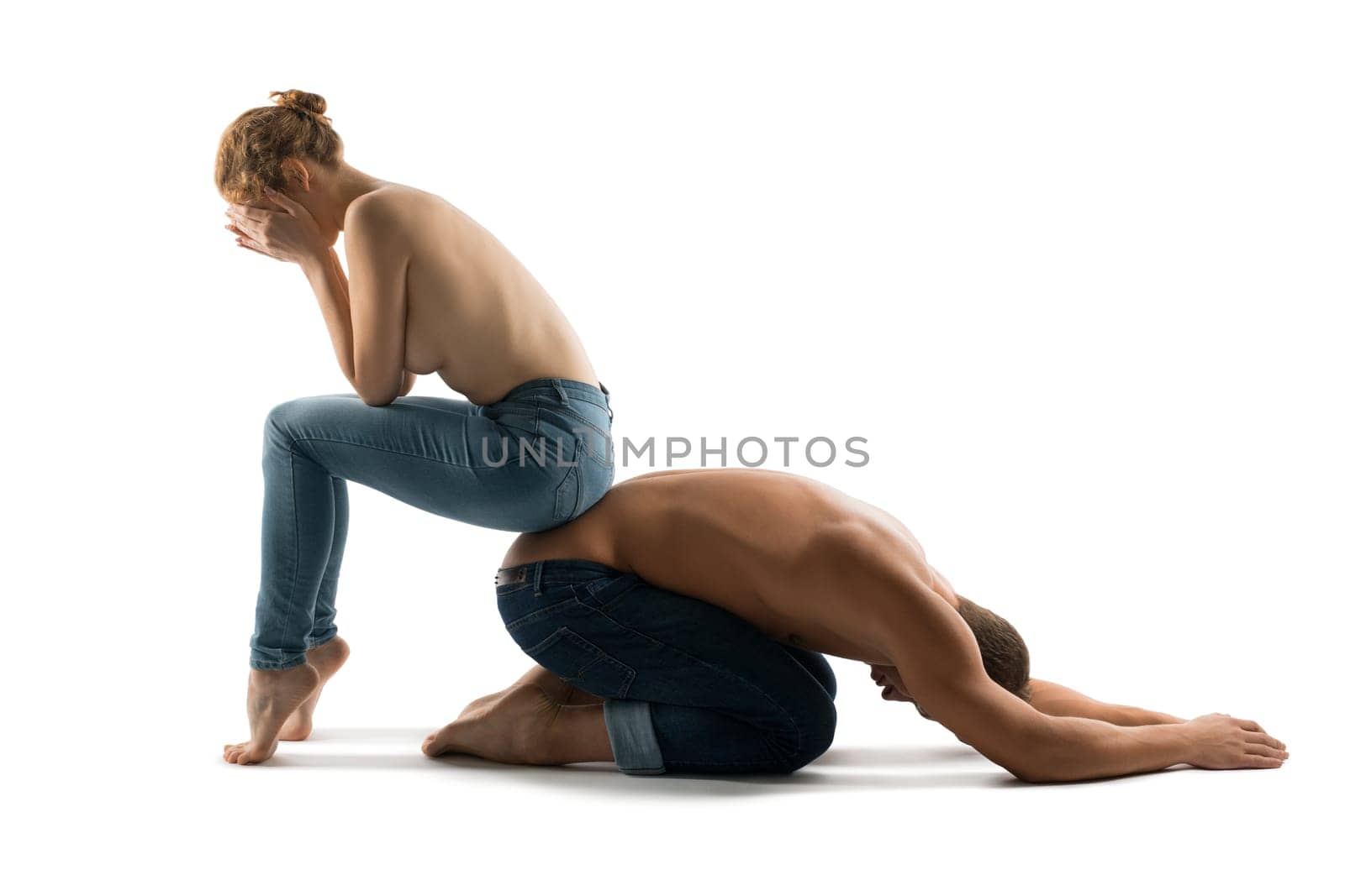 Side view of unrecognizable couple covering faces on white background and showing concept of intimate problems