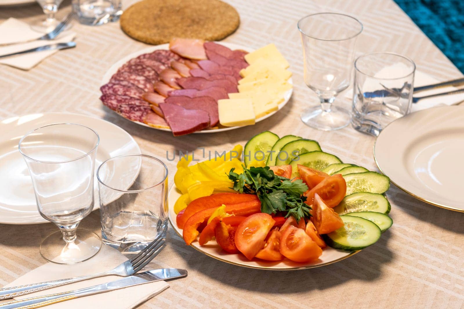 Shot of the table set up with assorted cut fresh vegetables, cold cuts, olives