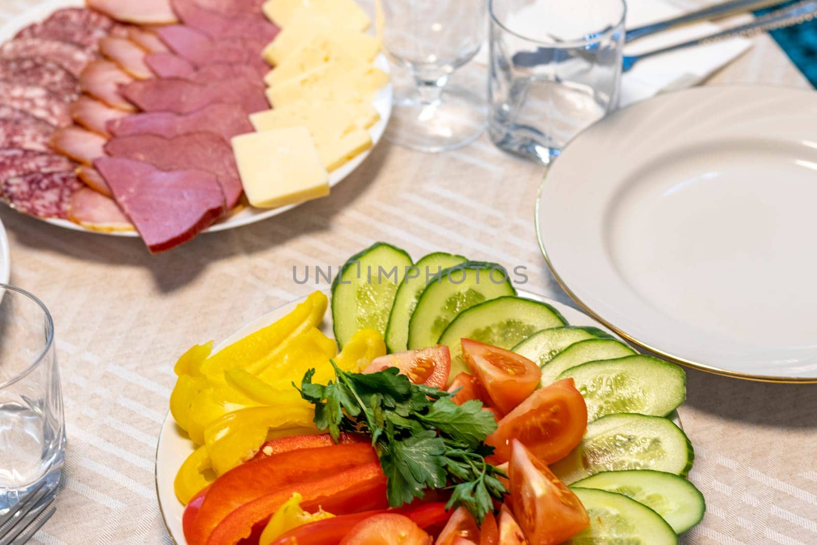 Shot of the table set up with assorted cut fresh vegetables, cold cuts, olives