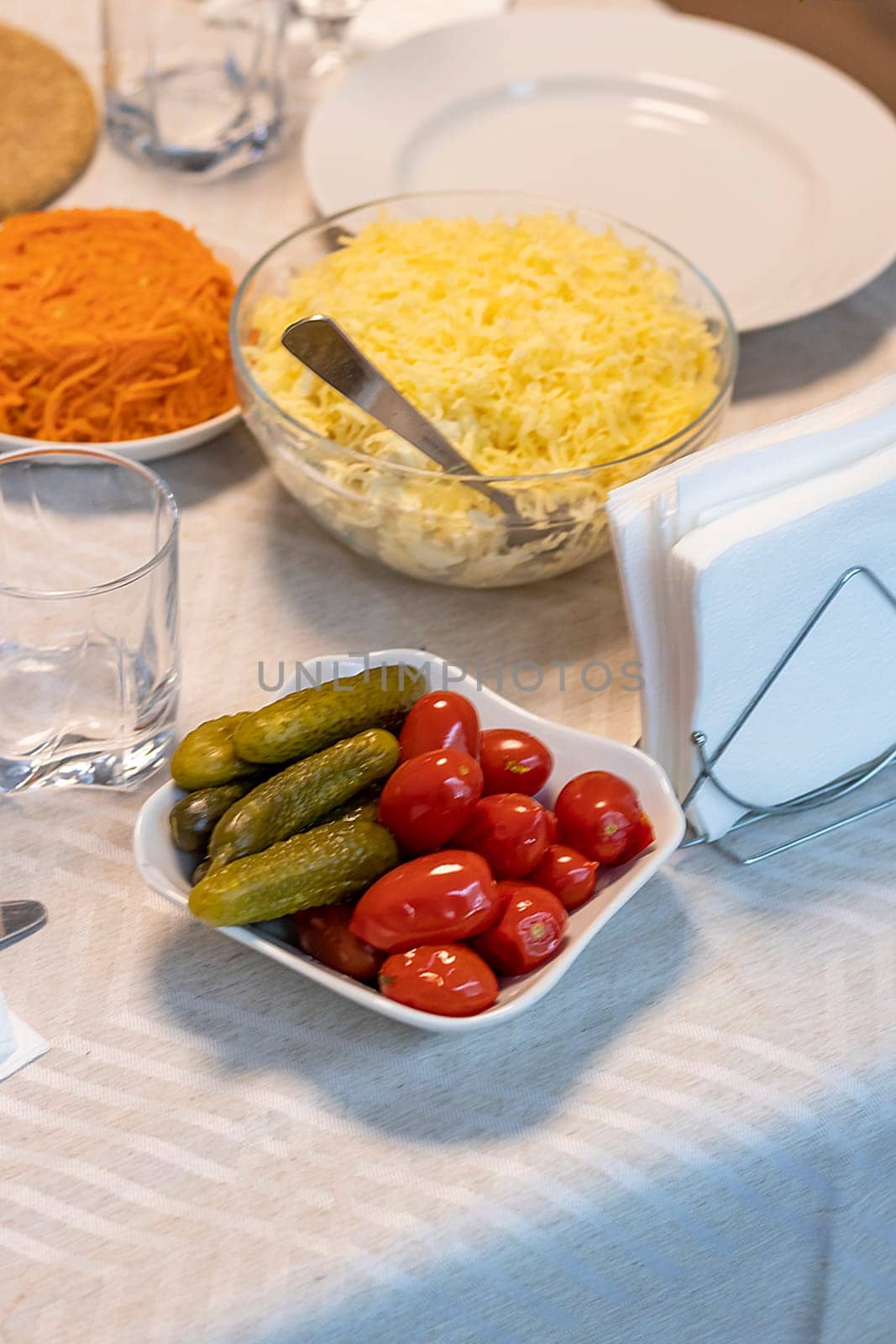 Shot of the table set up with assorted cut fresh vegetables, cold cuts, olives, salads.