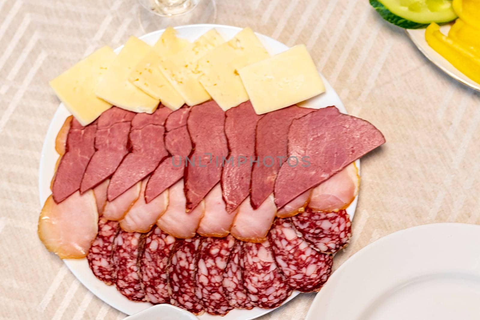 Shot of the table set up with assorted cut fresh vegetables, cold cuts, olives, salads.