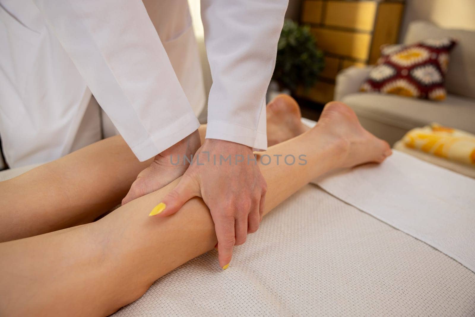 A soothing leg massage is being expertly performed in a calm, comfortable, and inviting environment for relaxation