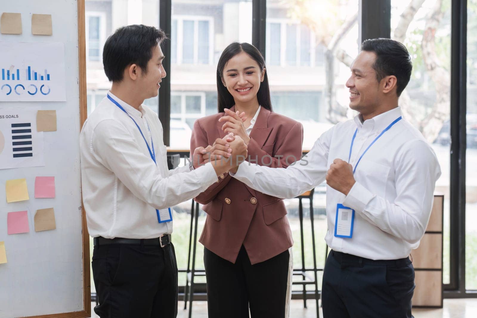 Professional businessmen shake hands to congratulate after business success. by wichayada