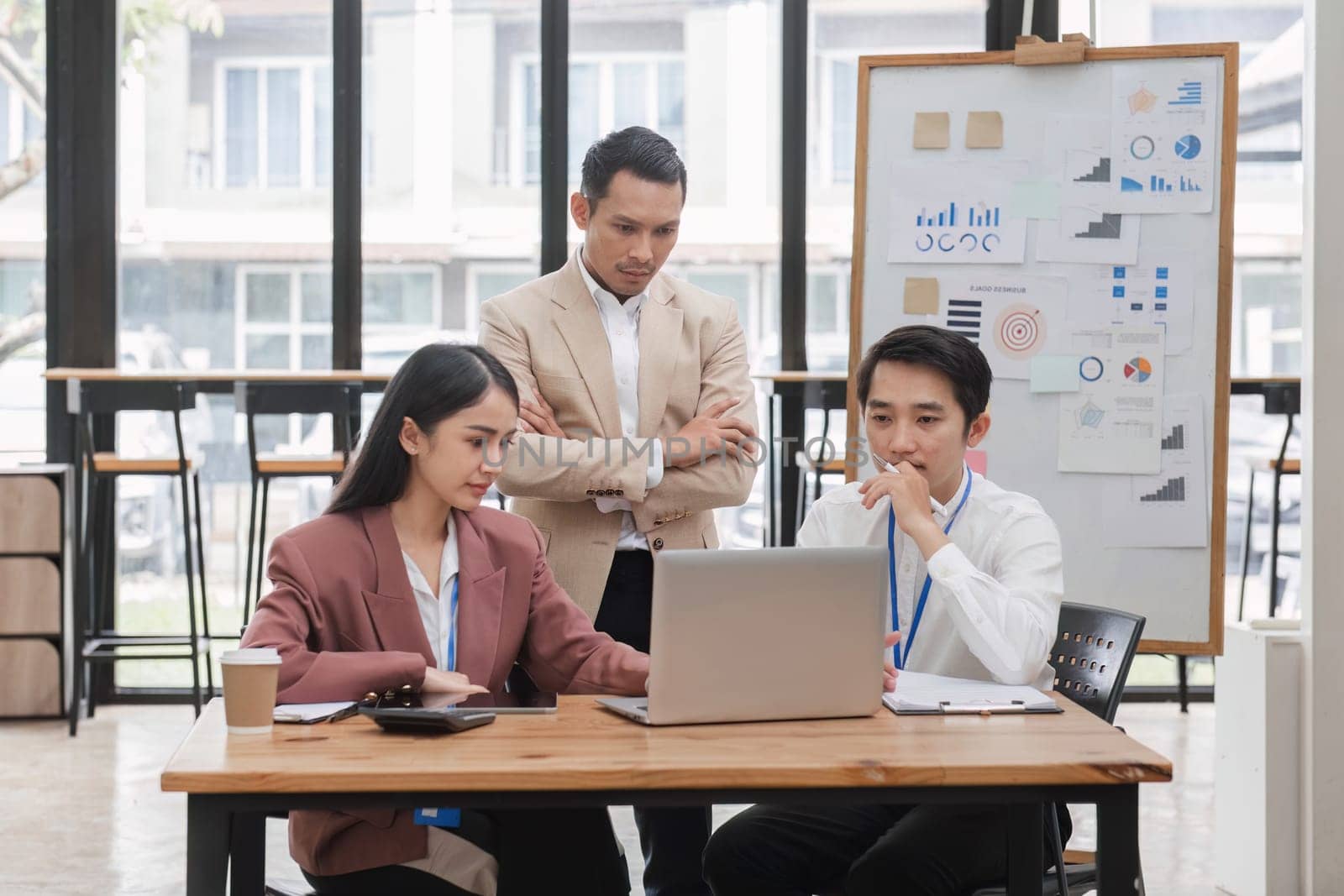 Group of business people working together and solving the problem of working stress in the meeting room at the office. by wichayada