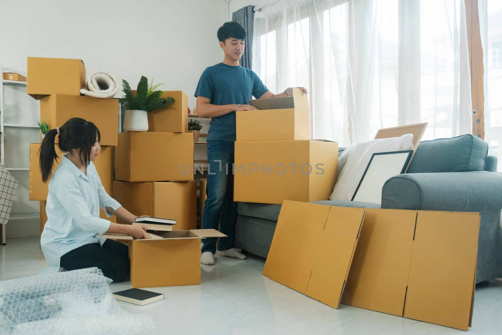 Asian young happy new married couple moving to their new house or real estate. by ijeab