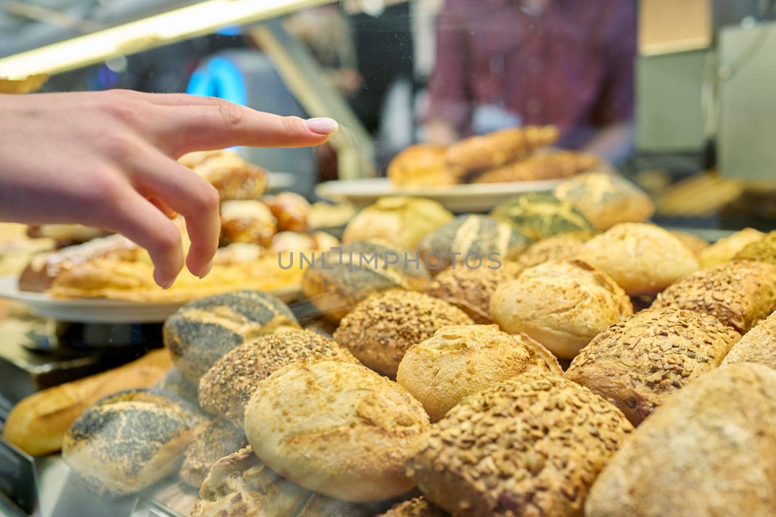 Close-up of a bakery pastry shop display with fresh buns. Delicious fresh pastries, flour food, bakery cafeteria small business concept