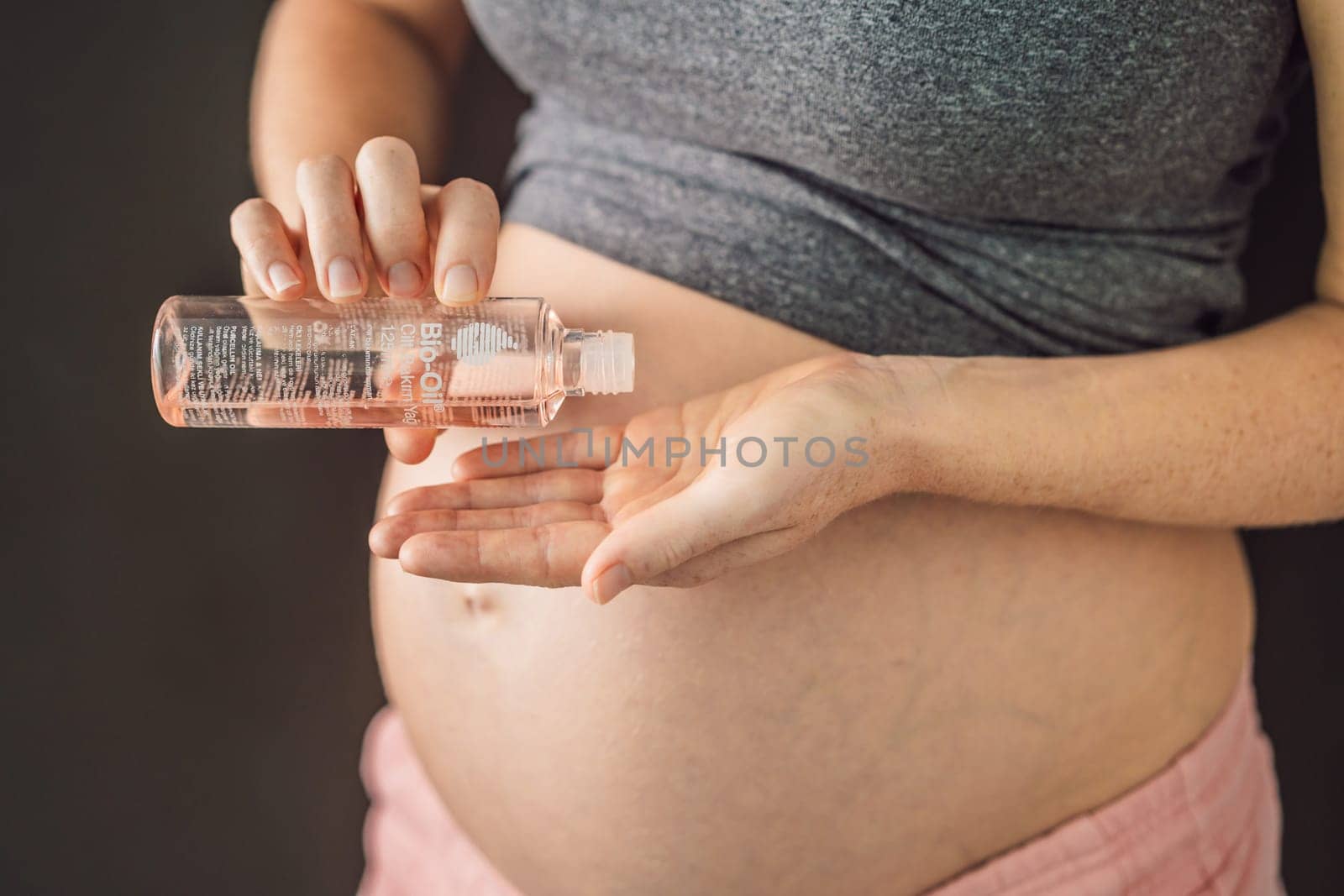 Turkiye, Antalya 02.02.2022: Woman holds Bio Oil, a nurturing choice for pregnant women. A soothing image of care and wellness during pregnancy.