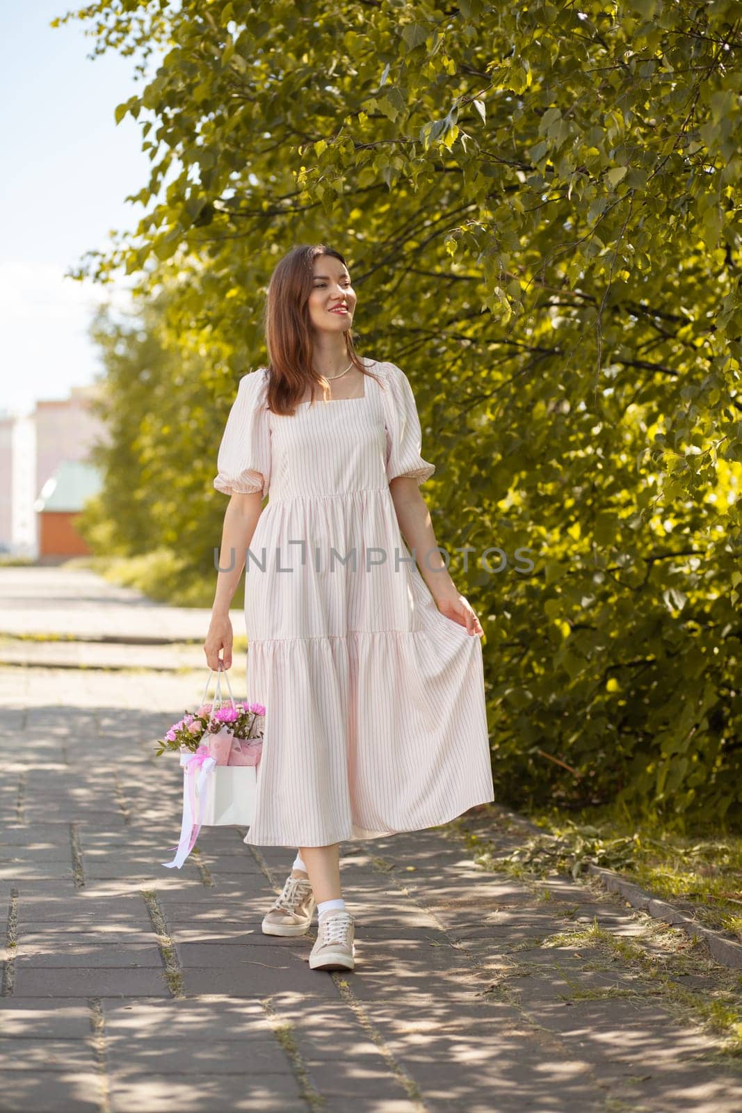 Beautiful girl with flowers, in a dress, glasses and sneakers. by AnatoliiFoto