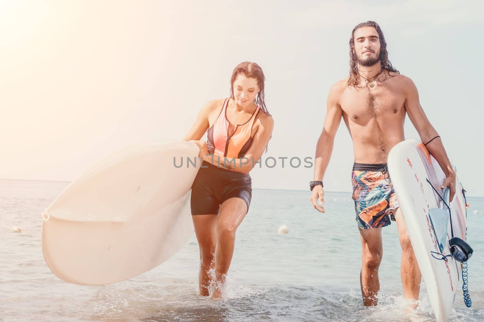 Woman man sea sup. Close up portrait of beautiful young caucasian woman with black hair and freckles looking at camera and smiling. Cute woman portrait in a pink bikini posing on sup board in the sea. by panophotograph