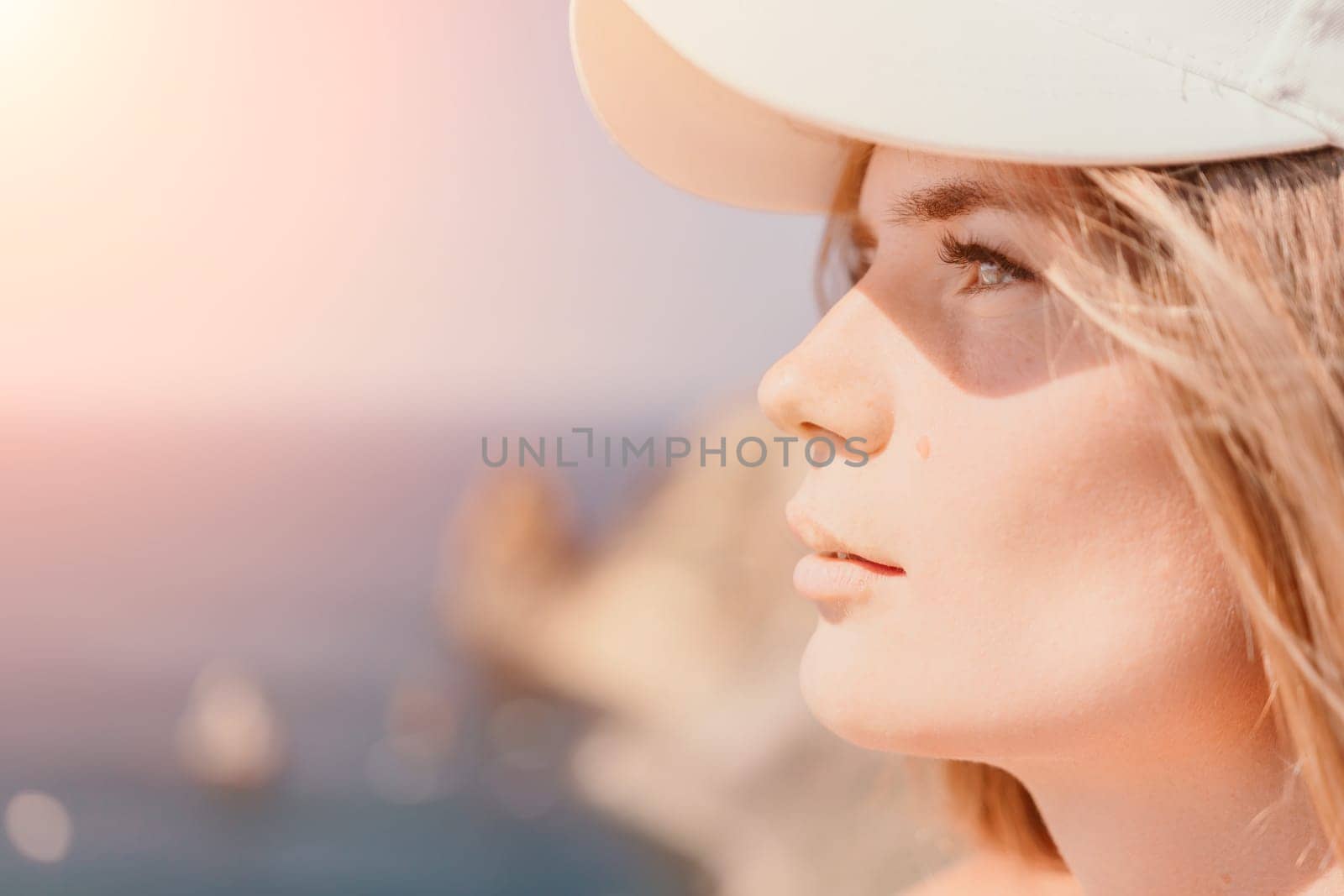 Woman travel sea. Happy tourist in hat enjoy taking picture outdoors for memories. Woman traveler posing on the beach at sea surrounded by volcanic mountains, sharing travel adventure journey by panophotograph