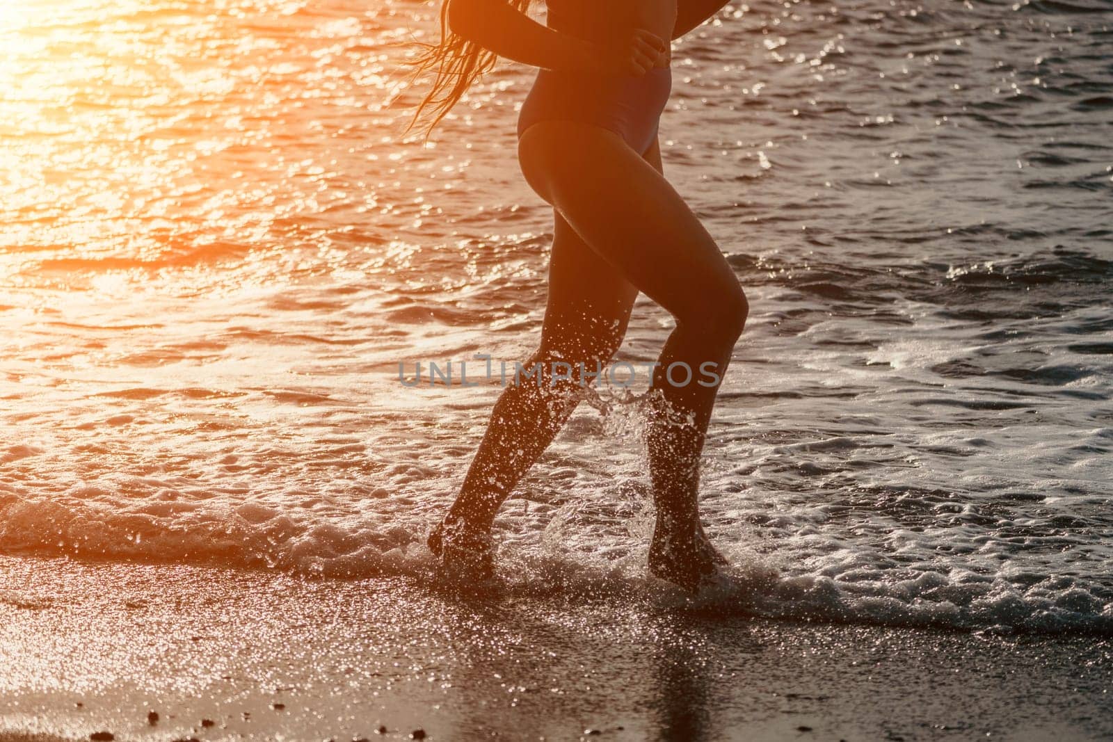 Running woman on a summer beach. A woman jogging on the beach at sunrise, with the soft light of the morning sun illuminating the sand and sea, evoking a sense of renewal, energy and health. by panophotograph