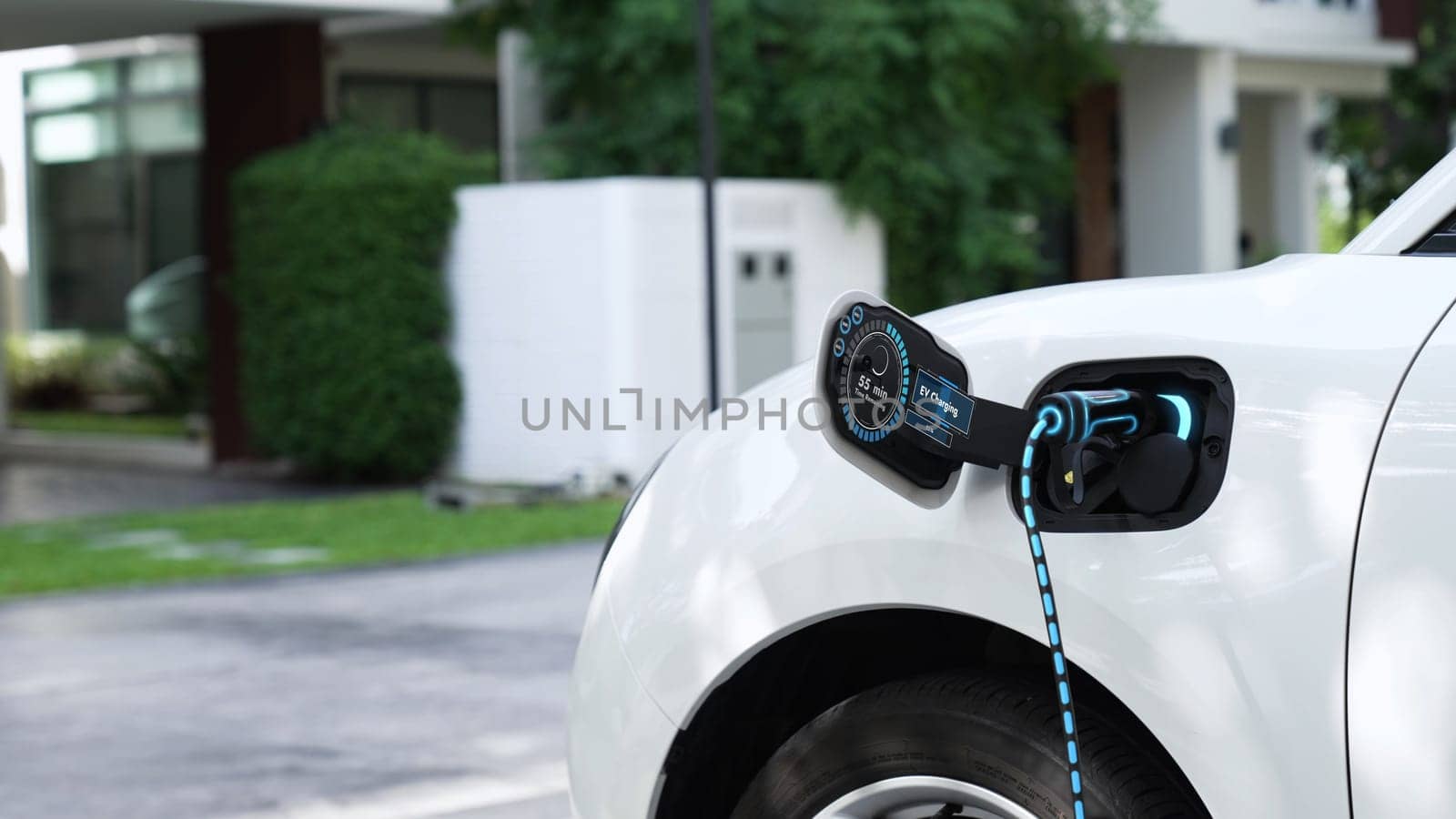 Electric car plugged in with home charging station. Peruse by biancoblue