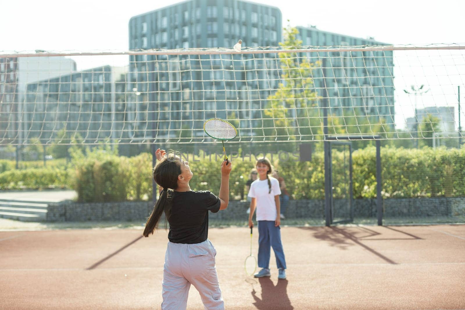 Two girls with badminton rackets on the football field. High quality photo