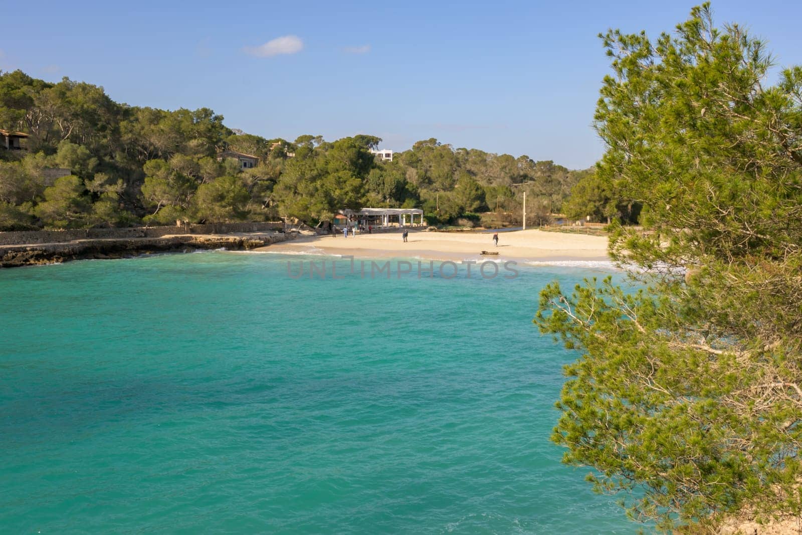 Tranquil beach with crystal clear turquoise waters and lush surroundings, cala mondrago, mallorca, balearic island, spain,
