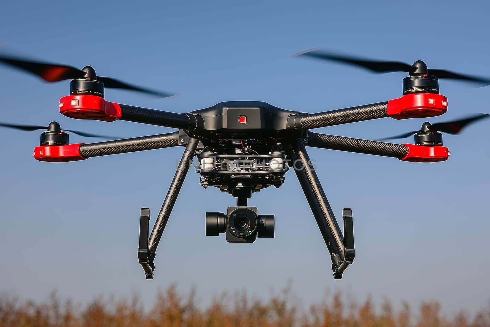 A drone is suspended in the air, prepared to capture aerial images in clear skies.
