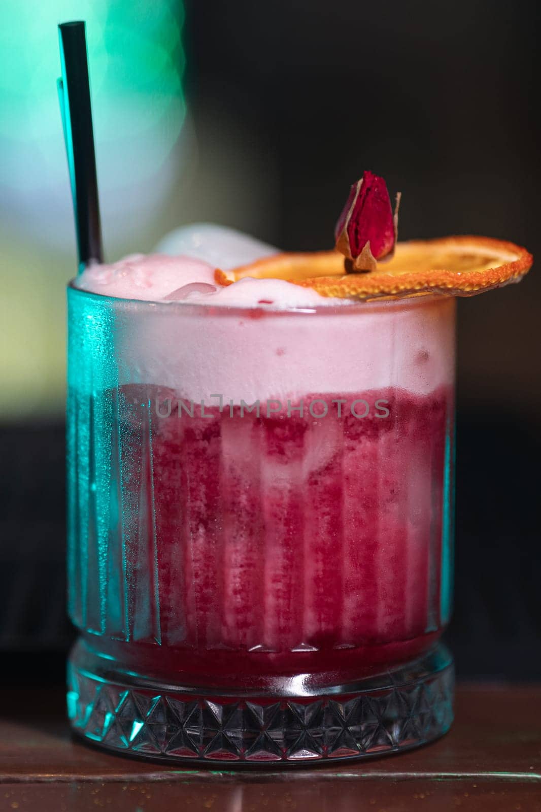 A beautiful bright cocktail. Restaurant, a glass with a drink is on the table.